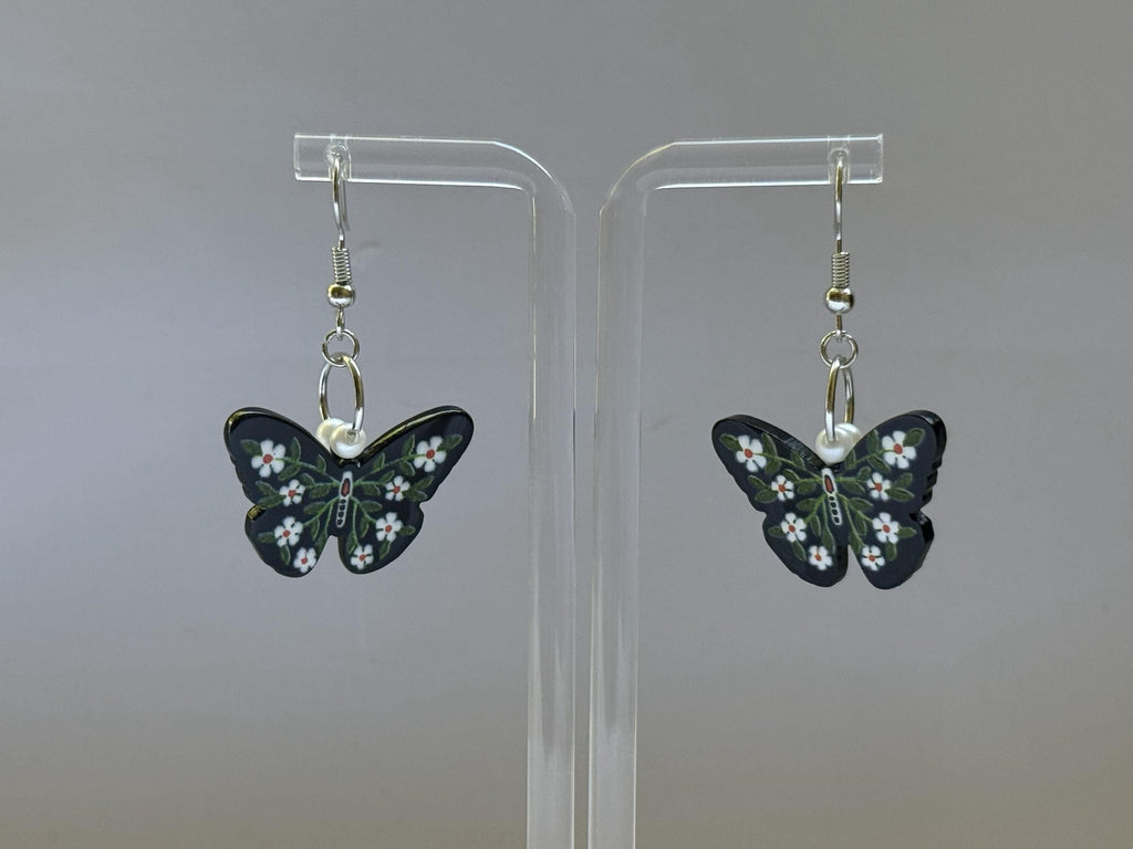 Dark Garden Earrings – Butterfly Dangles with White Flowers & Green Leaves