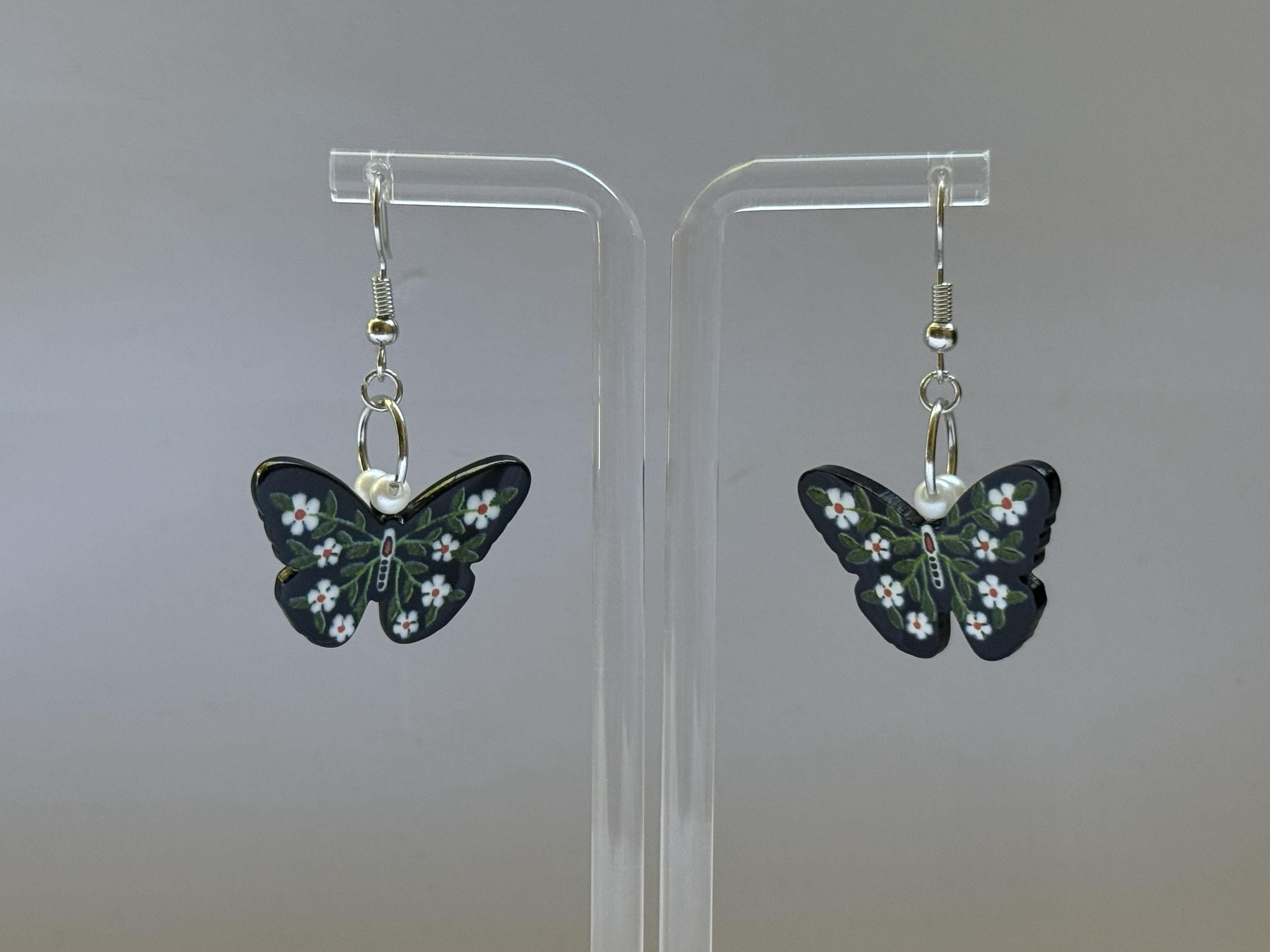 Dark Garden Earrings – Butterfly Dangles with White Flowers & Green Leaves